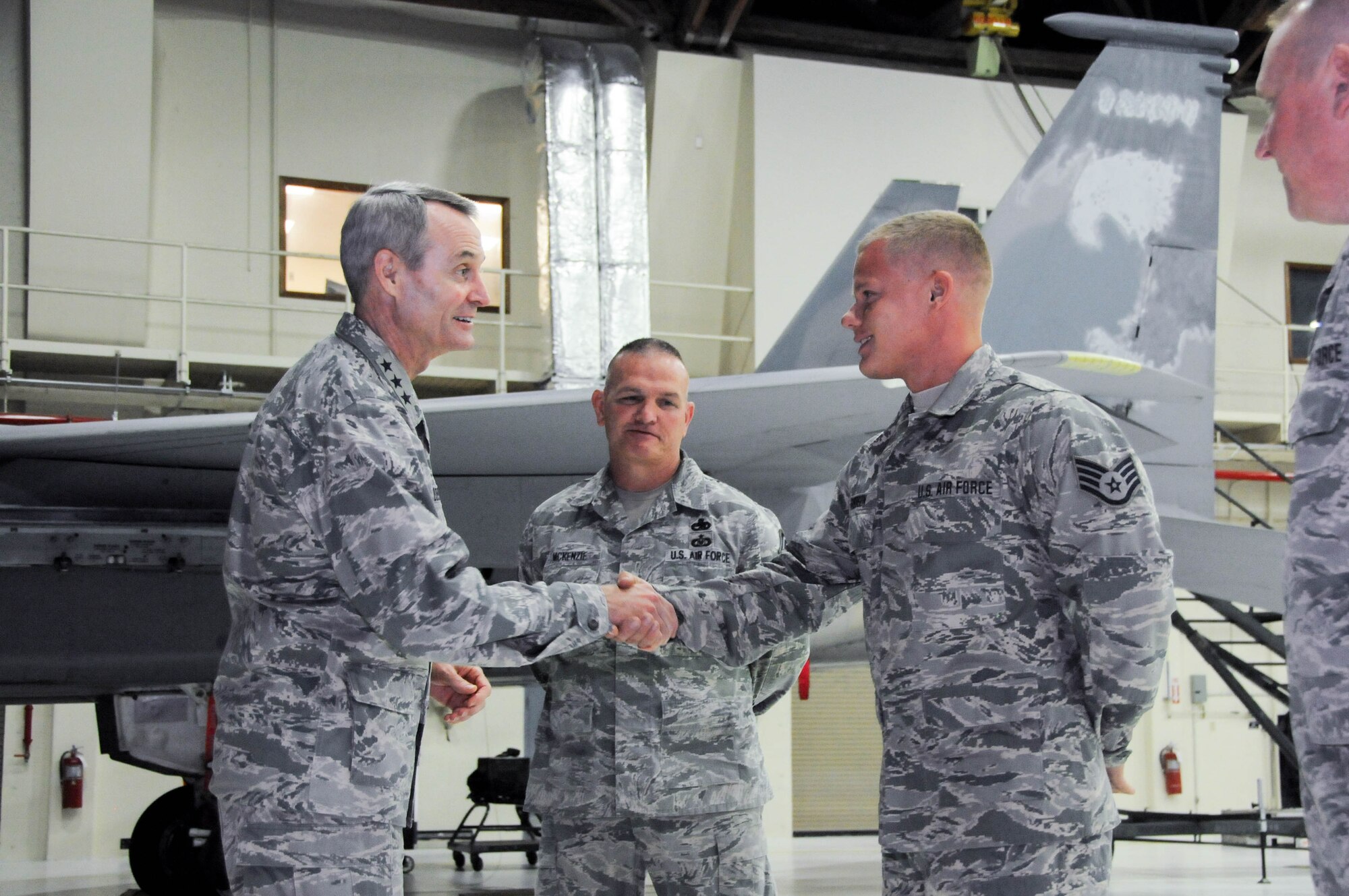 U.S. Air Force Lt. Gen. Darryl Roberson, commander of Air Education and Training Command, coins Staff Sgt. Christopher Robinson, 173rd Maintenance Group, July 7, 2016,in recognition of his superior performance at Kingsley Field, Ore. Roberson had a firsthand look at the unit's mission and capabilities, which includes training F-15C Eagle fighter pilots. The 173rd FW is aligned under AETC. (U.S. Air National Guard photo by Staff Sgt. Penny Snoozy)

