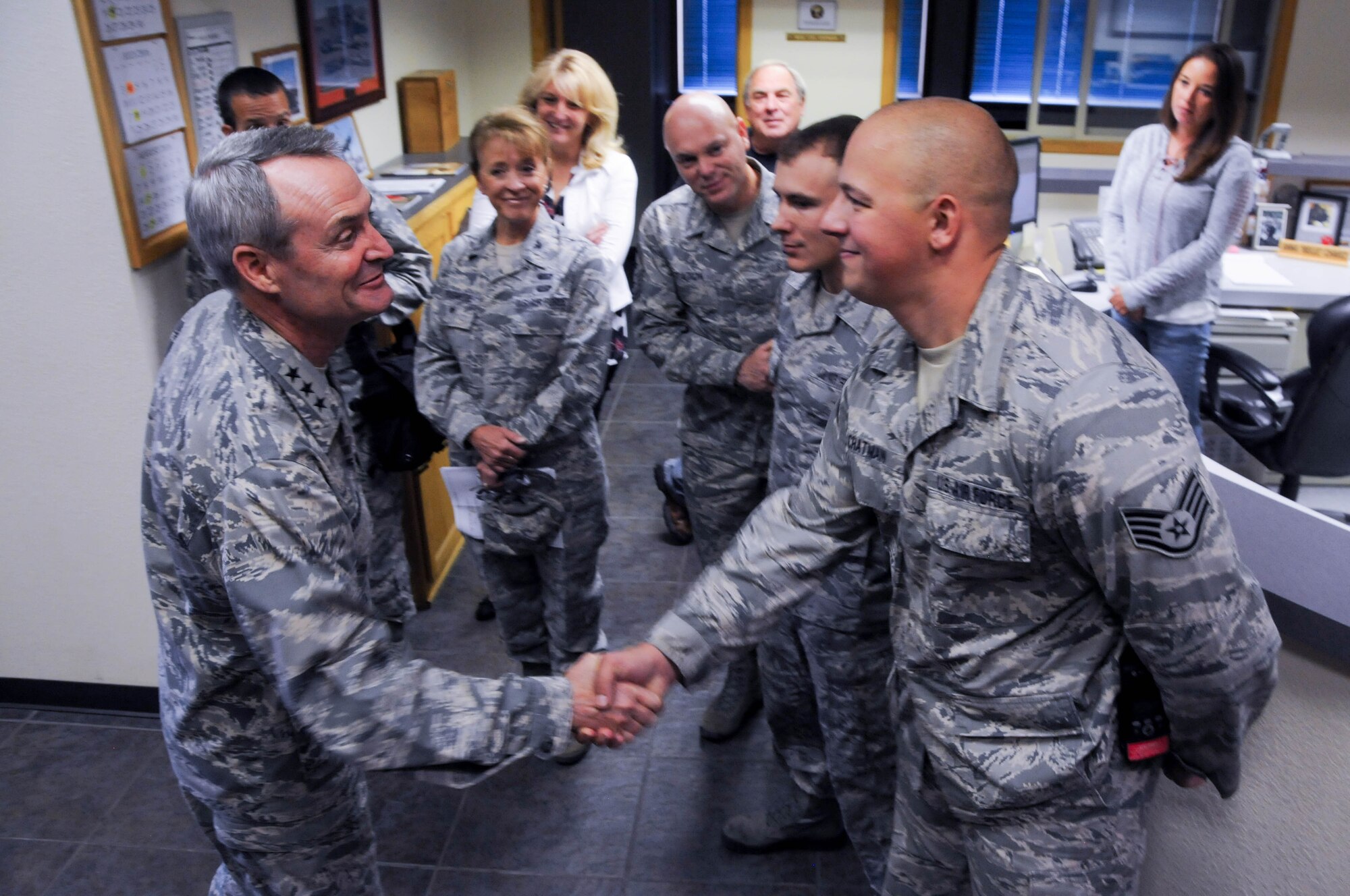 U.S. Air Force Lt. Gen. Darryl Roberson, commander of Air Education and Training Command, coins Staff Sgt. Jordan Chatman, 173rd electrical power production craftsman, July 7, 2016, in recognition of his superior performance at Kingsley Field, Ore. Roberson had a firsthand look at the unit's mission and capabilities, which includes training F-15C Eagle fighter pilots. The 173rd FW is aligned under AETC. (U.S. Air National Guard photo by Staff Sgt. Penny Snoozy)