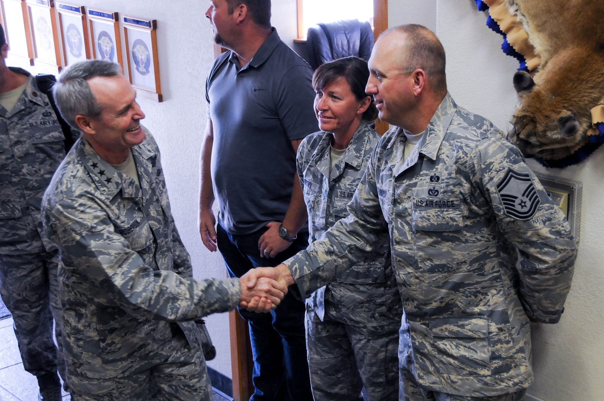 U.S. Air Force Lt. Gen. Darryl Roberson, commander of Air Education and Training Command, shakes hands with Senior Master Sgt. Kenneth Aubut, 173rd Civil Engineer Squadron, as he tours the squadron at Kingsley Field, Ore., July 7, 2016. Roberson had a firsthand look at the unit's mission and capabilities, which includes training F-15C Eagle fighter pilots. (U.S. Air National Guard photo by Staff Sgt. Penny Snoozy)