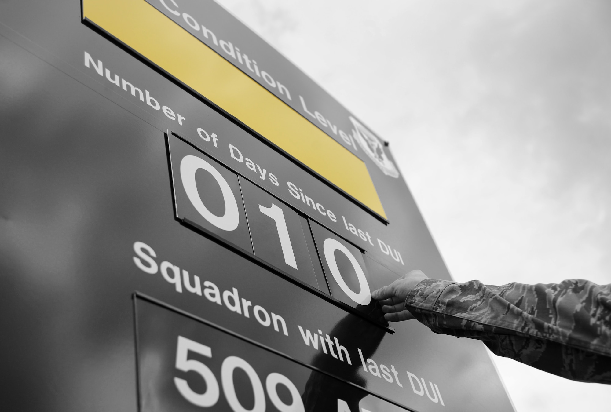 An Airman changes the number of days since the last DUI on the DUI condition level sign at Whiteman Air Force Base, Mo., July 13, 2016. In an attempt to further prevent Airmen from getting behind the wheel while intoxicated, the 509th Bomb Wing implemented a DUI Battle Plan. The plan serves as a tool for commanders and supervisors to ensure Airmen and members of Team Whiteman understand the risks of drunken driving and the importance of responsible decision making with regard to their safety and the safety of others on the road. (U.S. Air Force photo by Senior Airman Joel Pfiester)