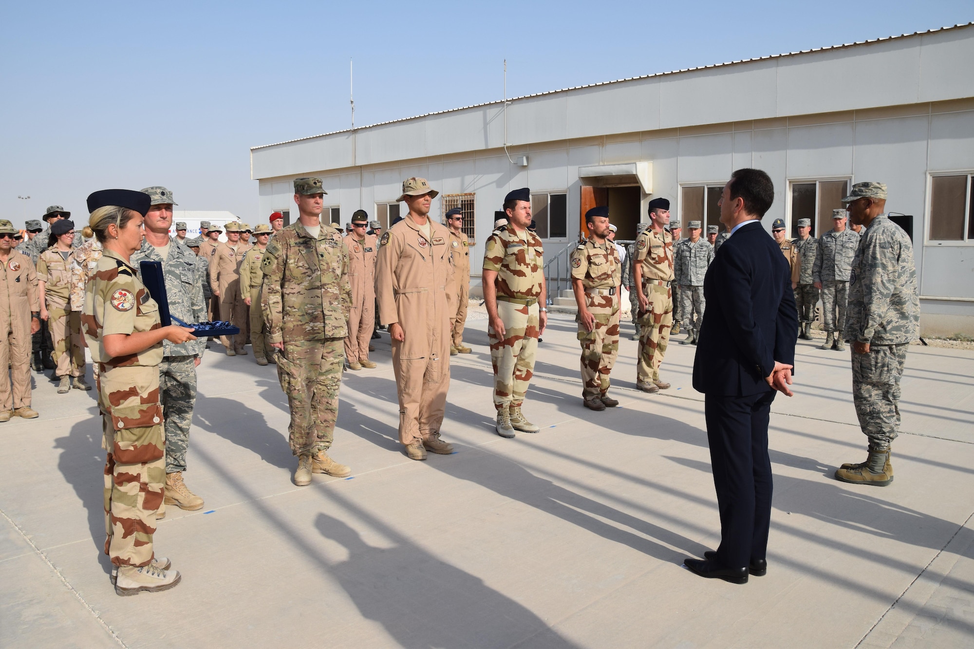 Recipients of the French National Defense Medal and Air Force Achievement Medal form a receiving line during the Bastille Day ceremony July 14, 2016, at Al Udeid Air Base, Qatar. Lt. Gen. Charles Brown, right, U.S. Air Forces Central Command commander, and Monsieur Eric Chevallier, center, Ambassador of France to Qatar, awarded the Air Force Achievement Medal and French National Defense Medal to French and American military members. The members   participated in operational activities to contain, dismantle and destroy Daesh and other terrorist organizations throughout the Southwest Asia region. (U.S. Air Force photo/Technical Sgt. Carlos J. Treviño/Released)