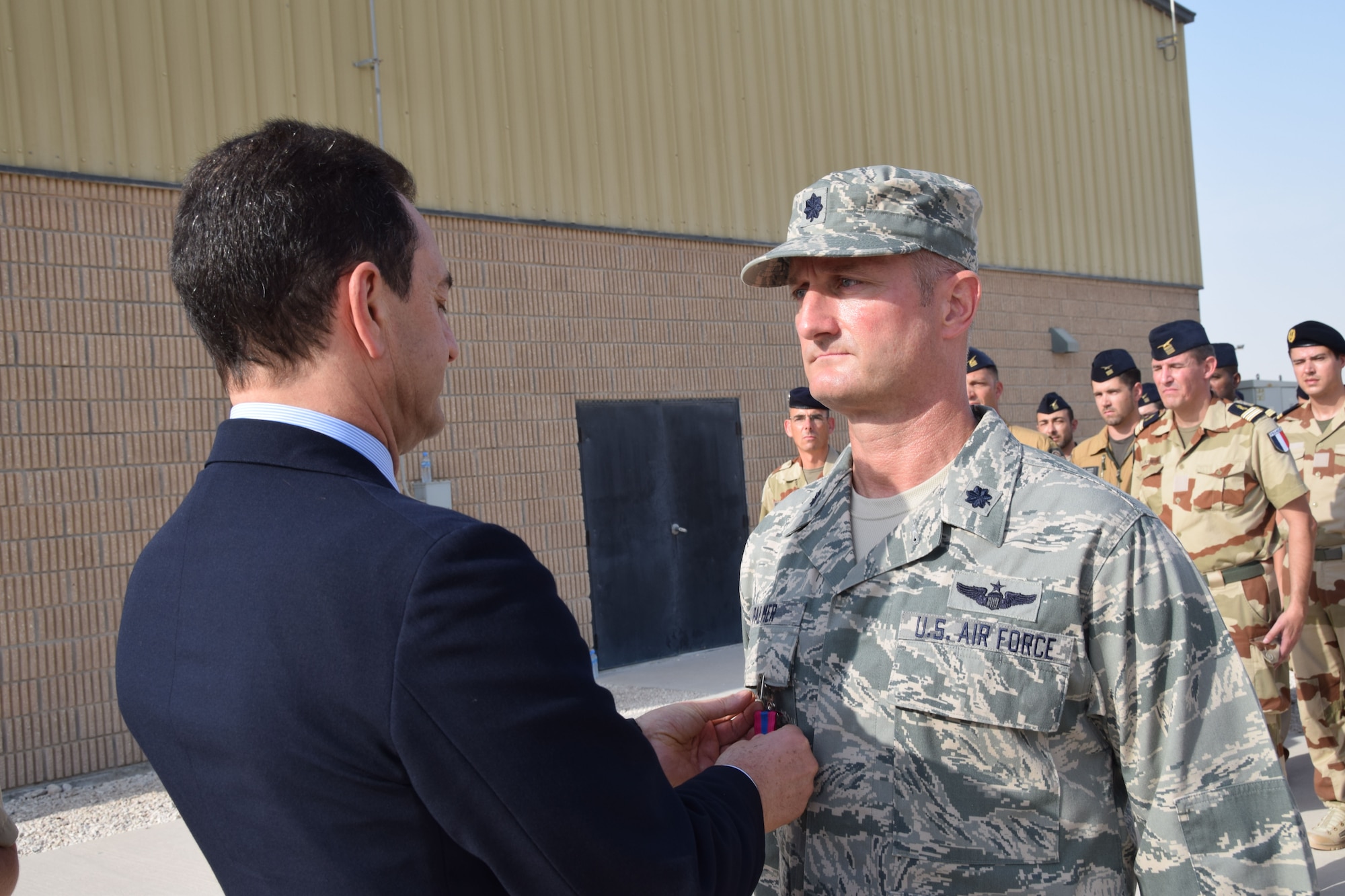 Monsieur Eric Chevallier, Ambassador of France to Qatar, pins a bronze French National Defense medal onto Lt. Col. Charles Palmer, chief of the coalition’s liaison cell, during the Bastille Day ceremony July 14, 2016, at Al Udeid Air Base, Qatar. The French National Day, often called “Bastille Day,” celebrates Liberty, Equality and Fraternity in France. France is one of 20 nations supporting the air Coalition that provides decisive air and space power to combat Daesh and other terrorist organizations and ensure the stability of the Southwest Asia region. (U.S. Air Force photo/Carlos J. Treviño/Released)
