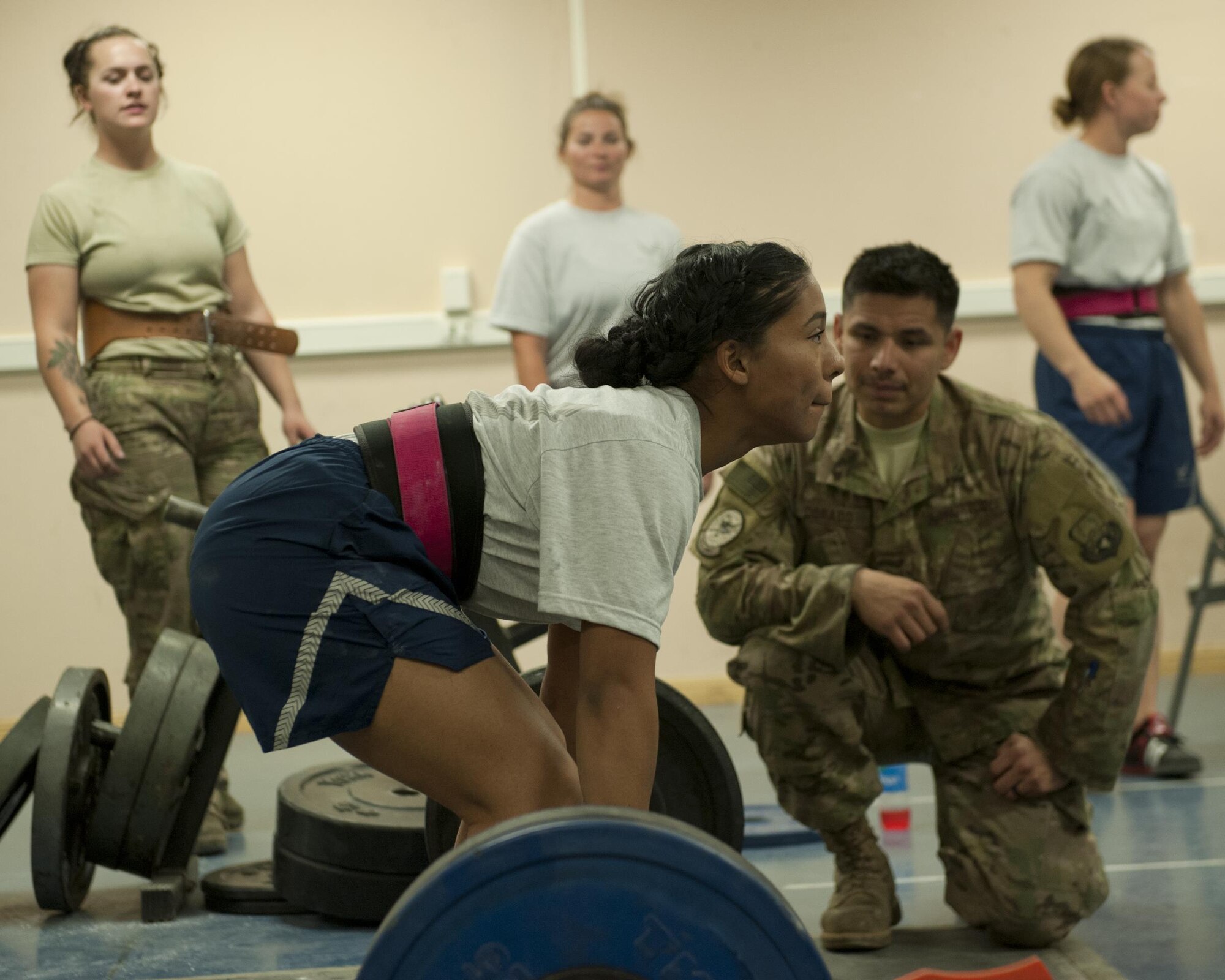 Airman First Class Sarah Deluna, 455th Expeditionary Aircraft Maintenance Squadron, prepares to perform a deadlift during a power lifting competition, July 15, 2016, Bagram Airfield, Afghanistan. Deluna ,along with Airmen across Bagram, participated in a power lifting competition that was organized by other Airmen in the 455th EAMXS. (U.S. Air Force photo by Capt. Korey Fratini)