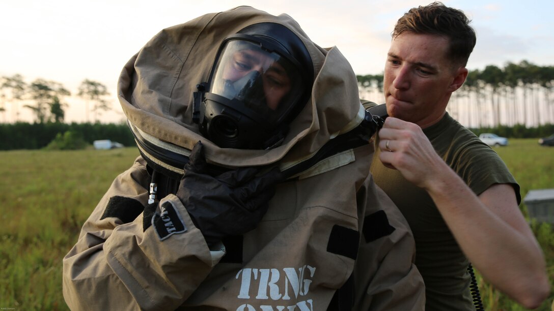 Sgt. Jarrod Roper receives help from Sgt. Christian Nelson as he dons his gear during a training exercise at Marine Corps Air Station Cherry Point, N.C., July 12, 2016. The training further refined the interoperability between MCAS Cherry Point’s Explosive Ordnance Disposal and 2nd Marine Aircraft Wing’s Chemical, Biological, Radiological and Nuclear Defense. Roper and Nelson are CBRN defense specialist with Marine Wing Headquarters Squadron 2. 