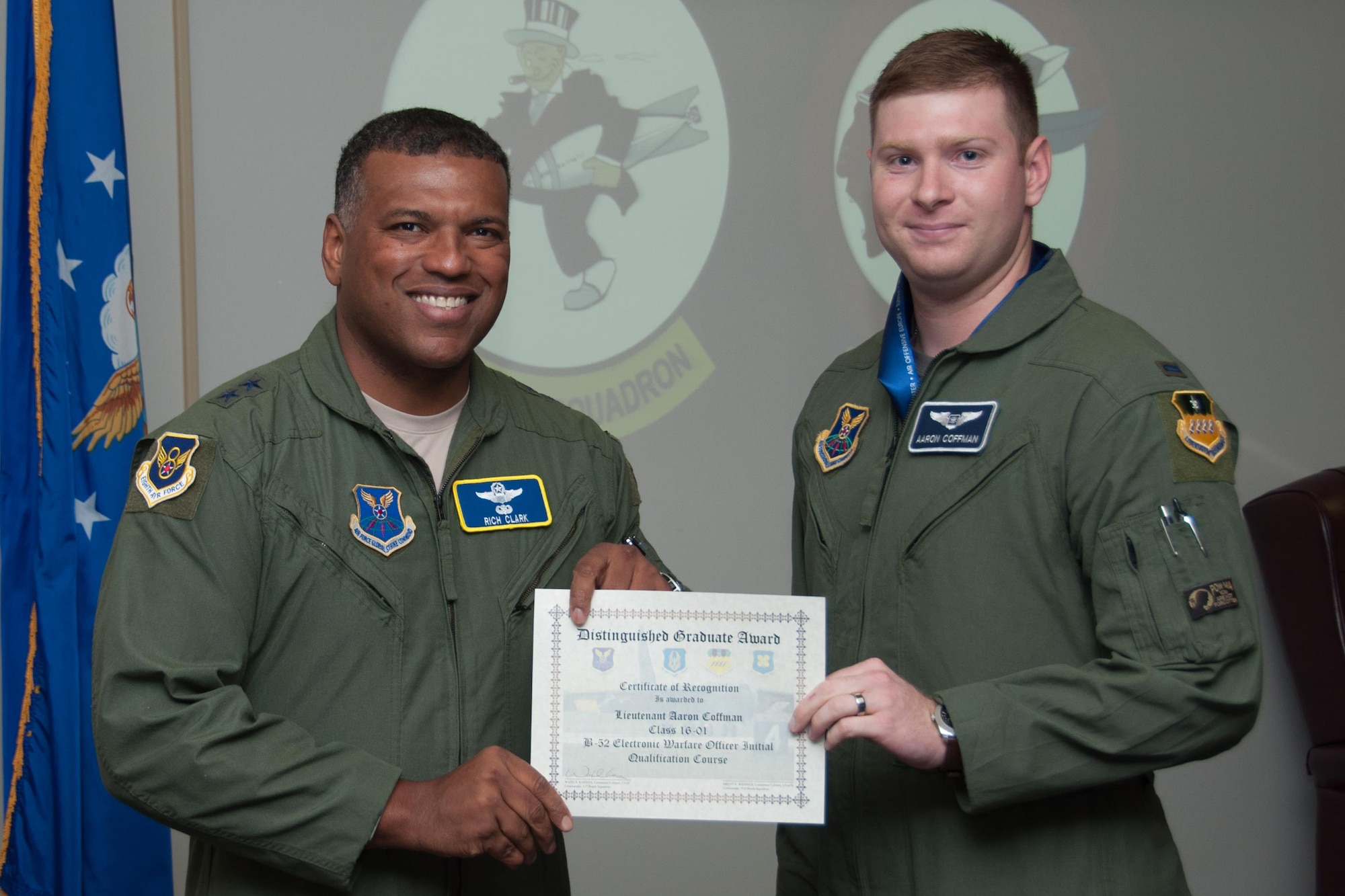U.S. Air Force, Maj. Gen. Richard Clark, Eighth Air Force commander, presents the Electronic Warfare Officer Distinguished Graduate Award to 1st Lt. Aaron Coffman during a Formal Training Unit (FTU) graduation ceremony, July 15, 2016, Barksdale Air Force Base, La. Coffman graduated from the FTU as an Electronic Warfare Officer on the B-52H Stratofortress. (U.S. Air Force photo by Master Sgt. Laura Siebert /Released)