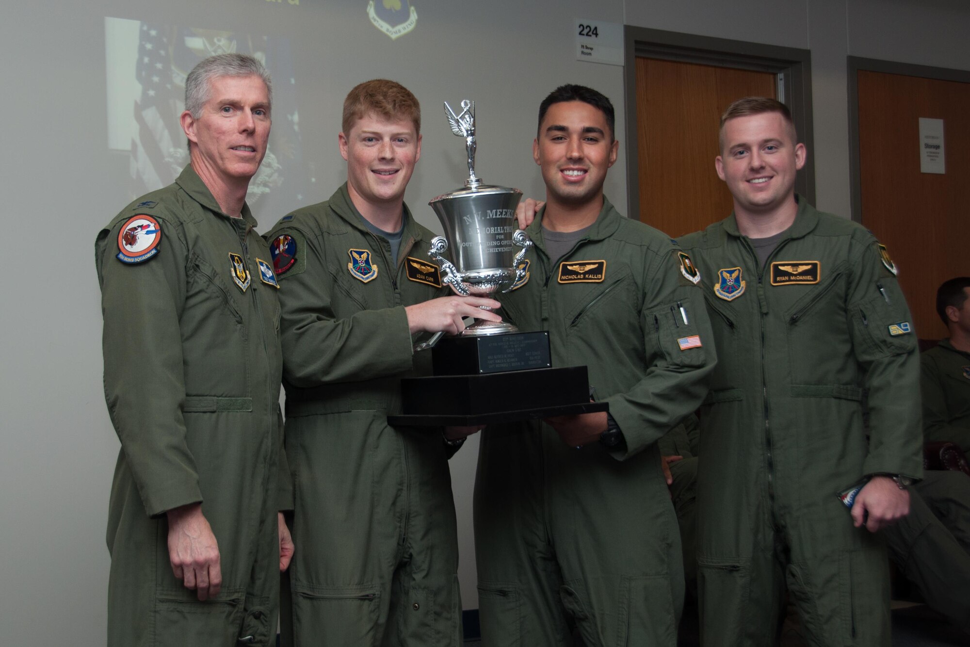 U.S. Air Force, Col. James Morriss, vice wing commander of the 307th Bomb Wing, presents the Meeks Outstanding Crew Award to crew TUFF 14 during a Formal Training Unit graduation ceremony, July 15, 2016, Barksdale Air Force Base, La. The award is presented to the student aircrew that performs the best throughout the flight line phase of training, and the crew members are; Pilot – 1st Lt. Adam Carr, Electronic Warfare Officer –1st  Lt Nicholas Kallis and Weapon Systems Officer– 1st  Lt Ryan McDaniel. (U.S. Air Force photo by Master Sgt. Laura Siebert /Released)