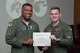 U.S. Air Force, Maj. Gen. Richard Clark, Eighth Air Force commander, presents the Weapons Systems Officer Distinguished Graduate Award to 1st Lt.  Ryan McDaniel during a Formal Training Unit (FTU) graduation ceremony, July 15, 2016, Barksdale Air Force Base, La. McDaniel graduated from the FTU as an Electronic Warfare Officer on the B-52H Stratofortress. (U.S. Air Force photo by Master Sgt. Laura Siebert /Released)