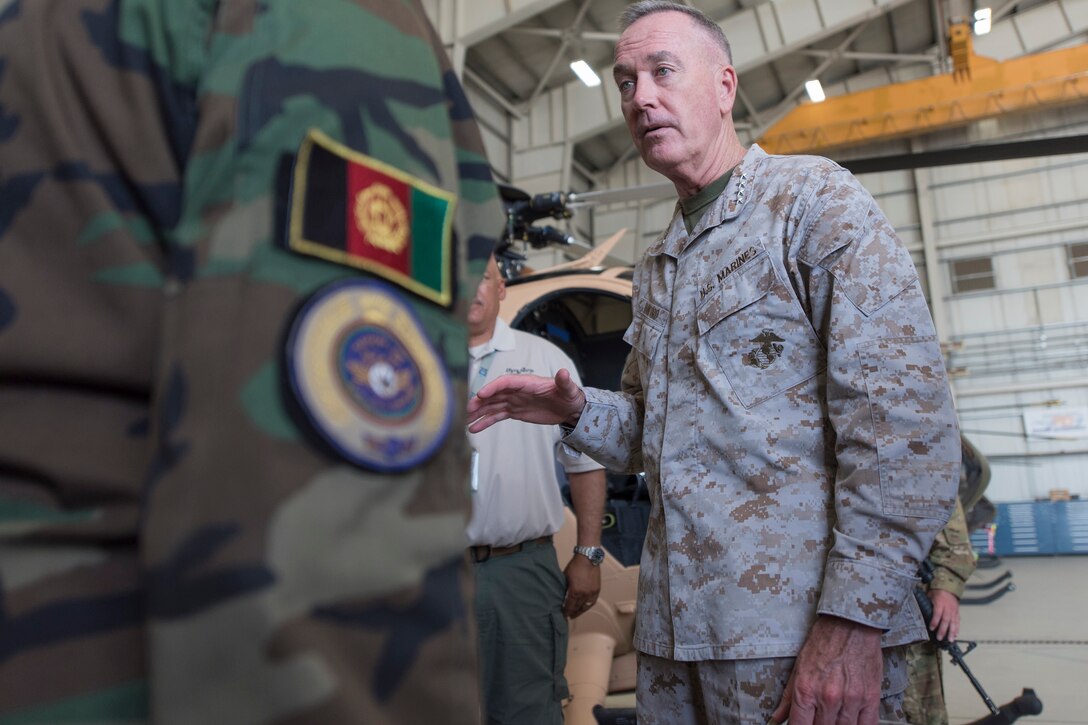 Marine Corps Gen. Joe Dunford, chairman of the Joint Chiefs of Staff, speaks with an Afghan service member participating in the Train, Advise, Assist Command – Air program in Kabul, Afghanistan, July 16, 2016. DoD photo by Navy Petty Officer 2nd Class Dominique A. Pineiro