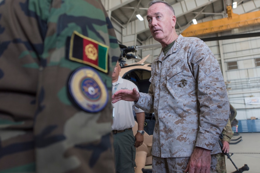 Marine Corps Gen. Joe Dunford, chairman of the Joint Chiefs of Staff, speaks with an Afghan service member participating in the Train, Advise, Assist Command – Air program at Bagram Airfield, Afghanistan.