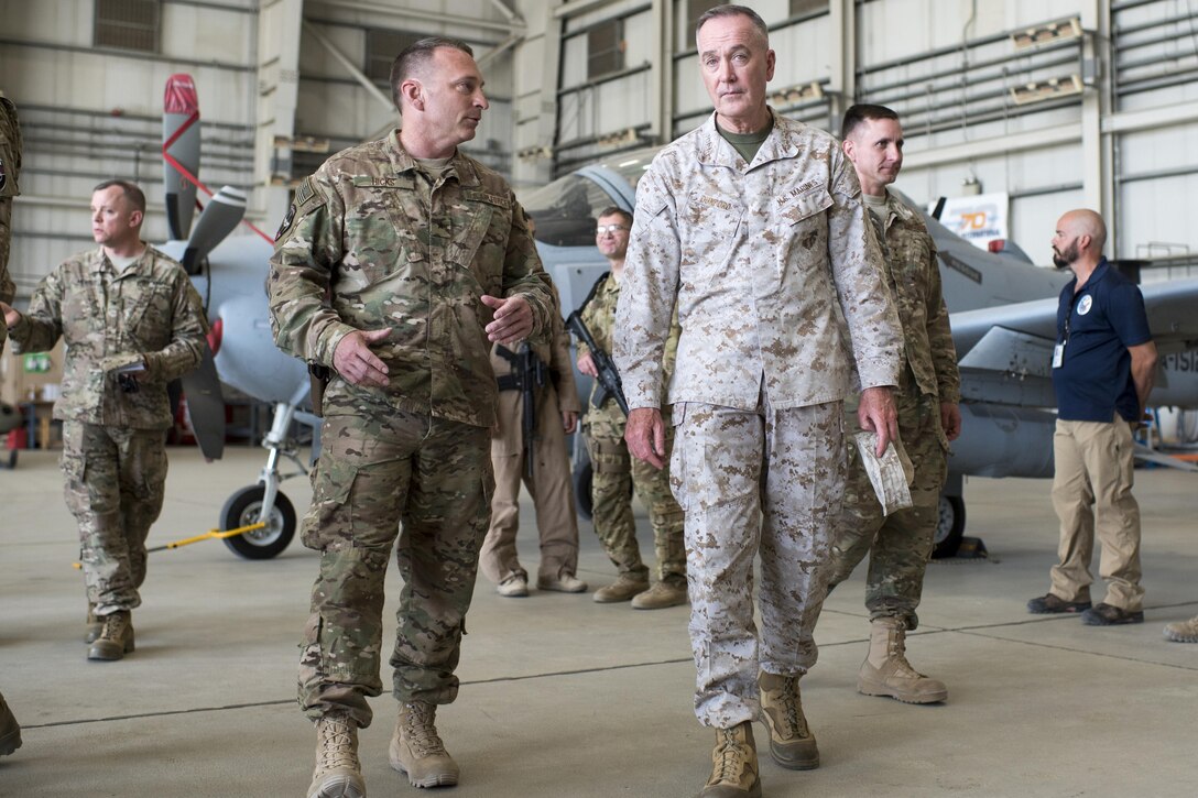 Marine Corps Gen. Joe Dunford, center right, chairman of the Joint Chiefs of Staff, talks with Air Force Brig. Gen. David W. Hicks, commanding general of Train, Advise, Assist Command – Air, while meeting with members of the command in Kabul, Afghanistan, July 16, 2016. Dunford met with key leaders and received briefings about the progress of the Afghan air force and its partnership with the command while assessing the Resolute Support mission in Afghanistan. DoD photo by Navy Petty Officer 2nd Class Dominique A. Pineiro