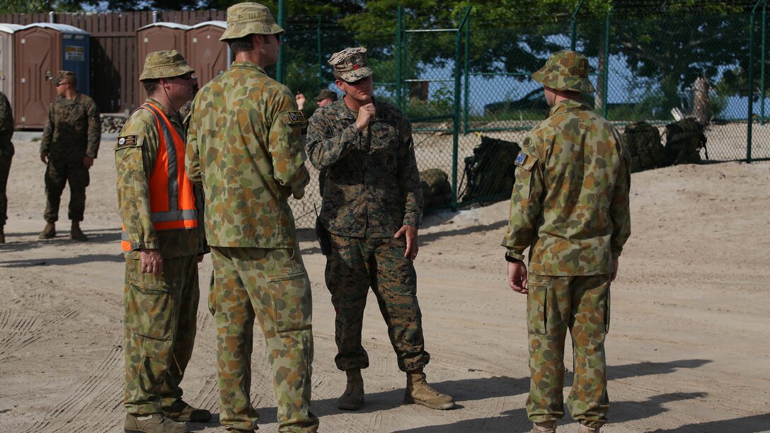 U.S. Marine Sgt. Max T. Humphreys (center) discusses gear and personnel movement during the 2nd Royal Australian Regiment's arrival to port at the Kawaihae Pier, Hawaii, from the HMAS Canberra July 12, 2016. The soldiers and Marines are participating in Rim of the Pacific 2016, a multinational military exercise, from June 29 to Aug. 4 in and around the Hawaiian Islands. RIMPAC helps the United States Marine Corps integrate joint and combined capabilities to conduct amphibious, offensive, defensive, and stability operations. Humphreys, a native of Pueblo, Colorado, is an embarkation specialist with Transportation Support Company, Combat Logistics Battalion 3, which supports III Marine Expeditionary Force. 
