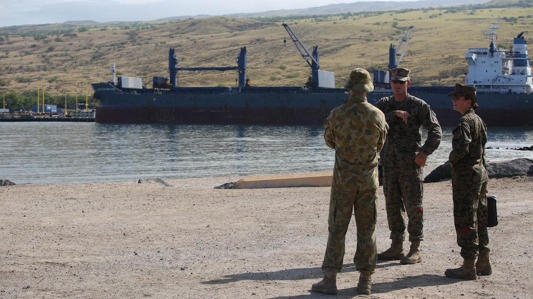 U.S. Marine Sgt. Max T. Humphreys (center) discusses gear and personnel movement during the 2nd Royal Australian Regiment's arrival to port at Kawaihae Pier, Hawaii from the HMAS Canberra, July 12, 2016. The soldiers and Marines are participating in Rim of the Pacific 2016, a multinational military exercise, from June 29 to Aug. 4 in and around the Hawaiian Islands. RIMPAC enables units to integrate joint and combined capabilities to conduct amphibious, offensive, defensive, and stability operations. Humphreys, a native of Pueblo, Colorado, is an embarkation specialist with Transportation Support Company, Combat Logistics Battalion 3, which supports III Marine Expeditionary Force. 