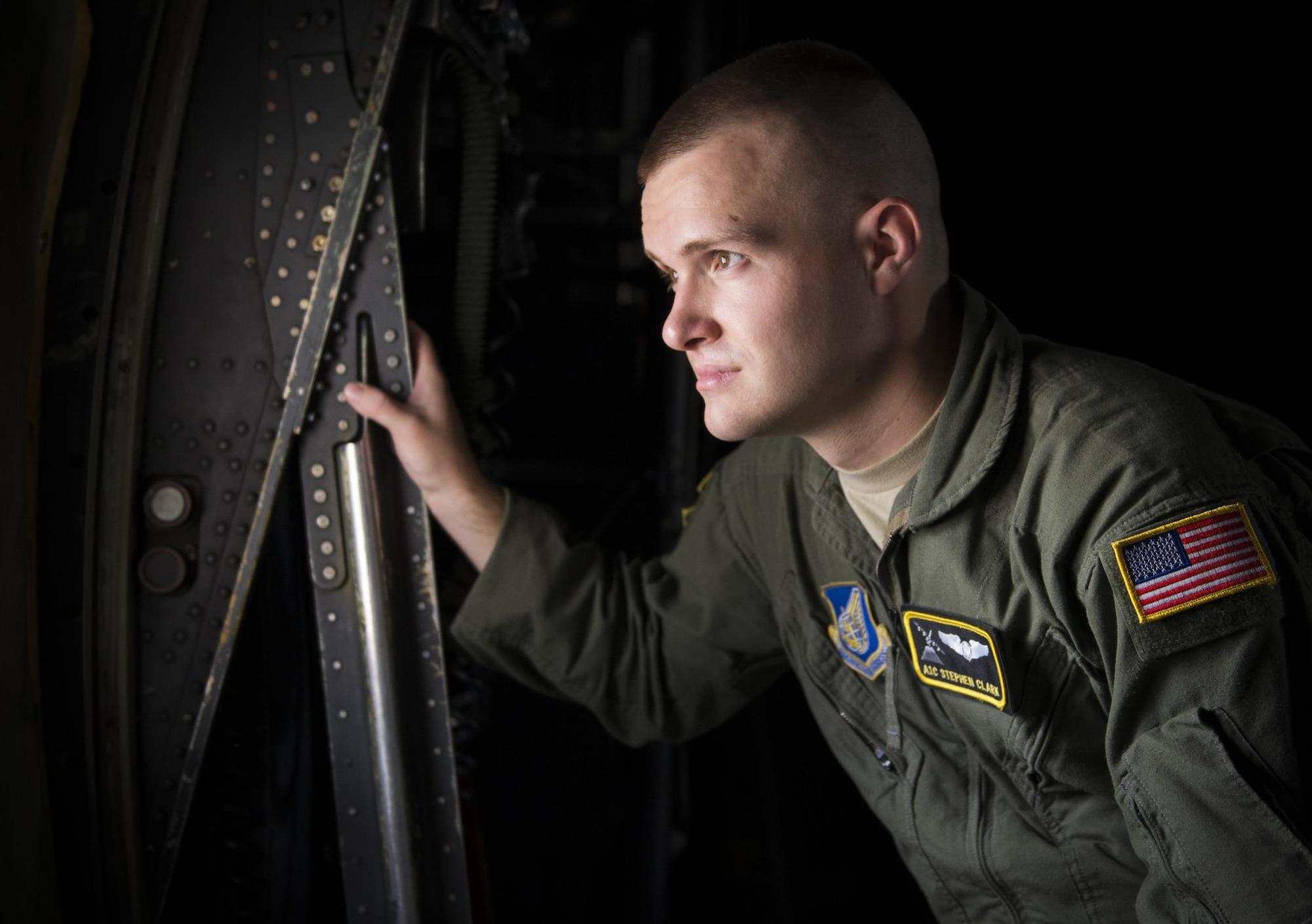 Airman 1st Class Stephen Clark, 36th Airlift Squadron C-130 Hercules loadmaster, looks out the window of a C-130H at Yokota Air Base, Japan, July 13, 2016. Yokota Air Base is the last active duty installation to operate the C-130H, and Clark is the last active duty loadmaster trained on the H model. (U.S. Air Force photo by Airman 1st Class Elizabeth Baker/Released)