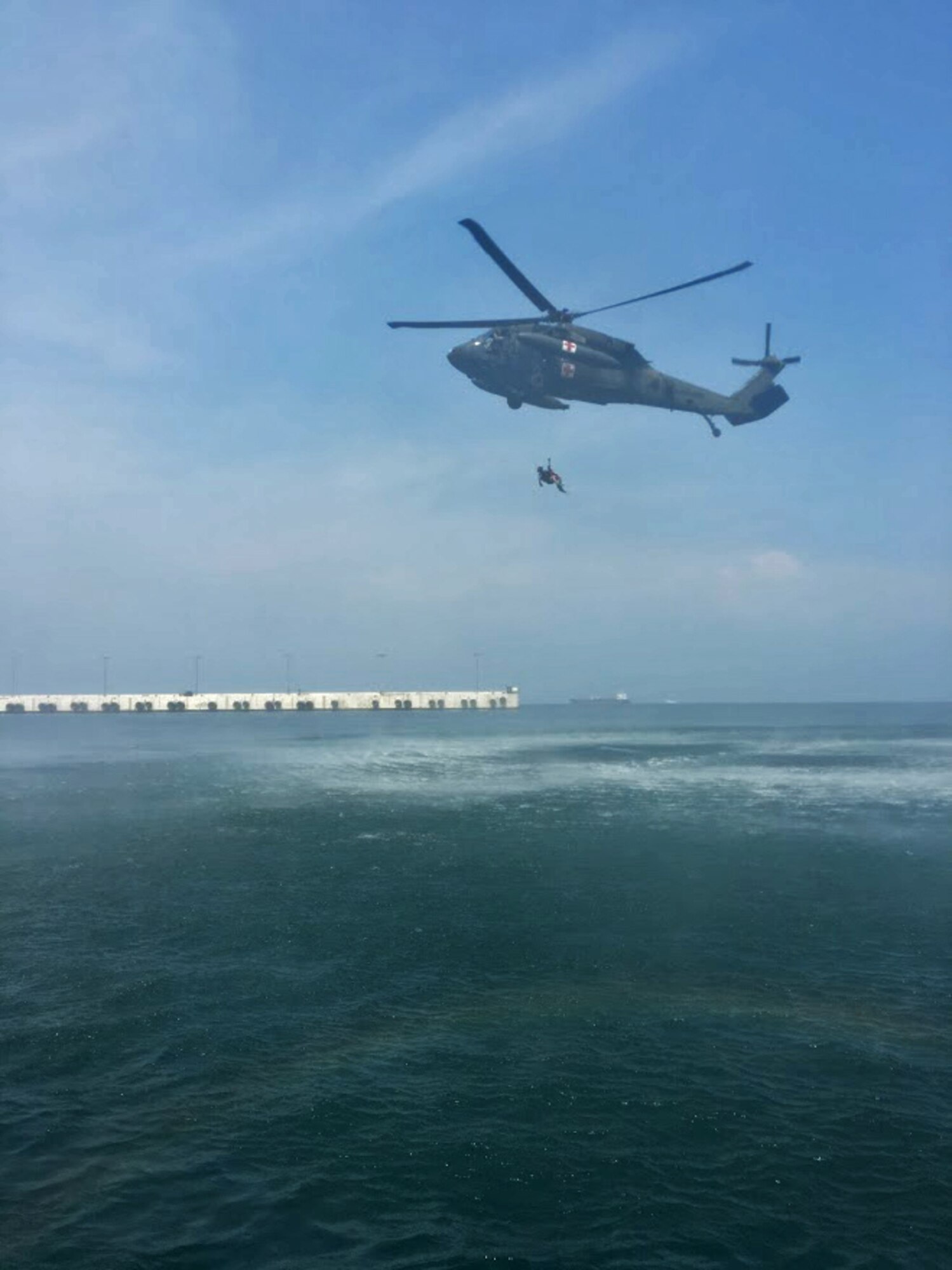 Members of the 1st Battalion, 228th Aviation Regiment from Joint Task Force-Bravo and Special Operations Command South conduct open water rescue training with Salvadorian military using an HH-60 Black Hawk Medical Evacuation helicopter May 26 in El Salvador. Salvadorian military members received incremental training that began with helicopter familiarization and progressed to rappelling from, and being hoisted into, the 1-228th AVN’s Black Hawks flying at heights of up to 90 feet. JTF-Bravo and other U.S. Military elements such as U.S. Army South Regionally Aligned Forces and Special-Purpose Marine Air, Ground Task Forces, under the auspices of U.S. Southern Command, routinely conduct combined training and exercises with Partner Nation security forces in multiple Central American nations, improving the safety and security in the CENTAM region and southern approaches to the United States. (Courtesy Photo)