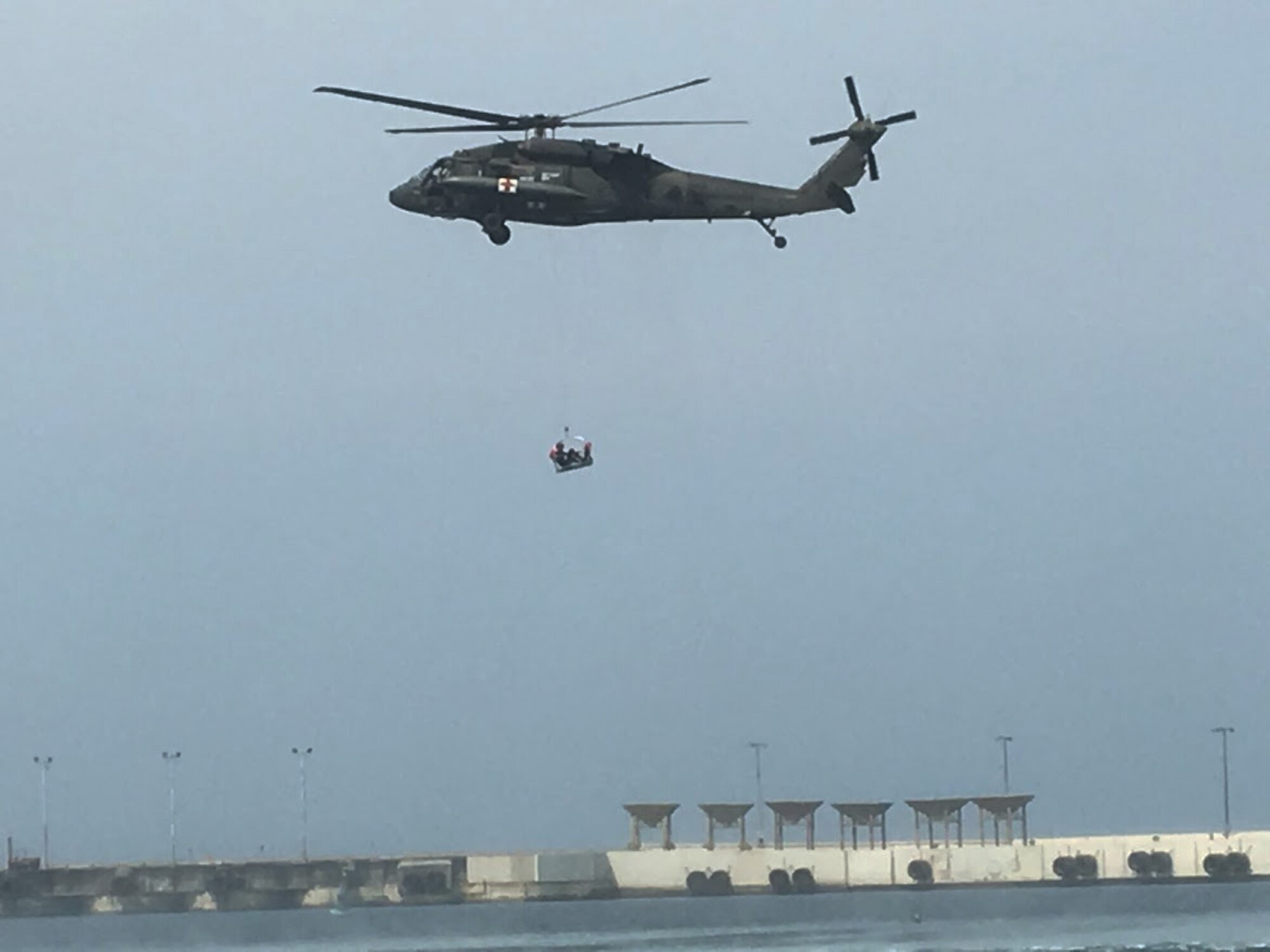 Members of the 1st Battalion, 228th Aviation Regiment from Joint Task Force-Bravo conduct open water rescue training with Salvadorian military using an HH-60 Black Hawk Medical Evacuation helicopter May 26 in El Salvador. JTF-Bravo and other U.S. Military elements such as U.S. Army South Regionally Aligned Forces and Special-Purpose Marine Air, Ground Task Forces, under the auspices of U.S. Southern Command, routinely conduct combined training and exercises with Partner Nation security forces in multiple Central American nations, improving the safety and security in the CENTAM region and southern approaches to the United States. (Courtesy Photo)