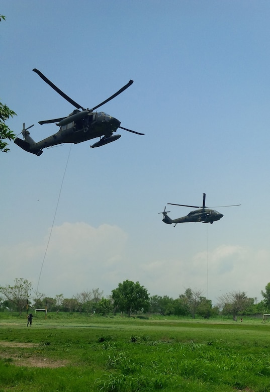 Members of the 1st Battalion, 228th Aviation Regiment from Joint Task Force-Bravo and Special Operations Command South conduct Fast Rope Insertion and Extraction System training from a UH-60 Black Hawk helicopter with Salvadorian military May 24 in El Salvador. Salvadorian military members received incremental training that began with helicopter familiarization and progressed to rappelling from, and being hoisted into, the 1-228th AVN’s Black Hawks flying at heights of up to 90 feet. This training is crucial to both U.S. and Salvadorian military members’ ability to safely conduct aerial operations for a variety of missions that include search and rescue, humanitarian aid and disaster relief, troop movements, counter-transnational organized crime operations and even firefighting efforts. (Courtesy Photo)