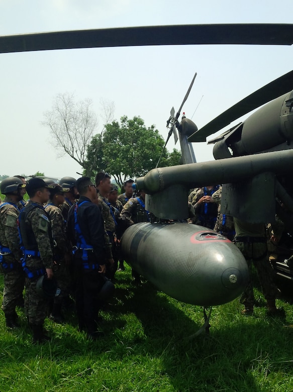 Members of the 1st Battalion, 228th Aviation Regiment from Joint Task Force-Bravo and Special Operations Command South conduct aircraft familiarization training on a UH-60 Black Hawk helicopter with Salvadorian military May 24 in El Salvador. JTF-Bravo and other U.S. Military elements such as U.S. Army South Regionally Aligned Forces and Special-Purpose Marine Air, Ground Task Forces, under the auspices of U.S. Southern Command, routinely conduct combined training and exercises with Partner Nation security forces in multiple Central American nations, improving the safety and security in the CENTAM region and southern approaches to the United States. According USSOUTHCOM officials, Salvadorian forces exemplify the command’s security cooperation objectives to enhance the capability of partners to operate successfully in contingency, peacekeeping, humanitarian, disaster and stability operations. (Courtesy Photo Illustration)