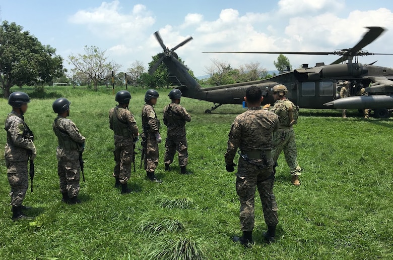 Members of the 1st Battalion, 228th Aviation Regiment from Joint Task Force-Bravo and Special Operations Command South conduct aircraft familiarization training on a UH-60 Black Hawk helicopter with Salvadorian military May 24 in El Salvador. JTF-Bravo and other U.S. Military elements such as U.S. Army South Regionally Aligned Forces and Special-Purpose Marine Air, Ground Task Forces, under the auspices of U.S. Southern Command, routinely conduct combined training and exercises with Partner Nation security forces in multiple Central American nations, improving the safety and security in the CENTAM region and southern approaches to the United States. (Courtesy Photo  Illustration)
