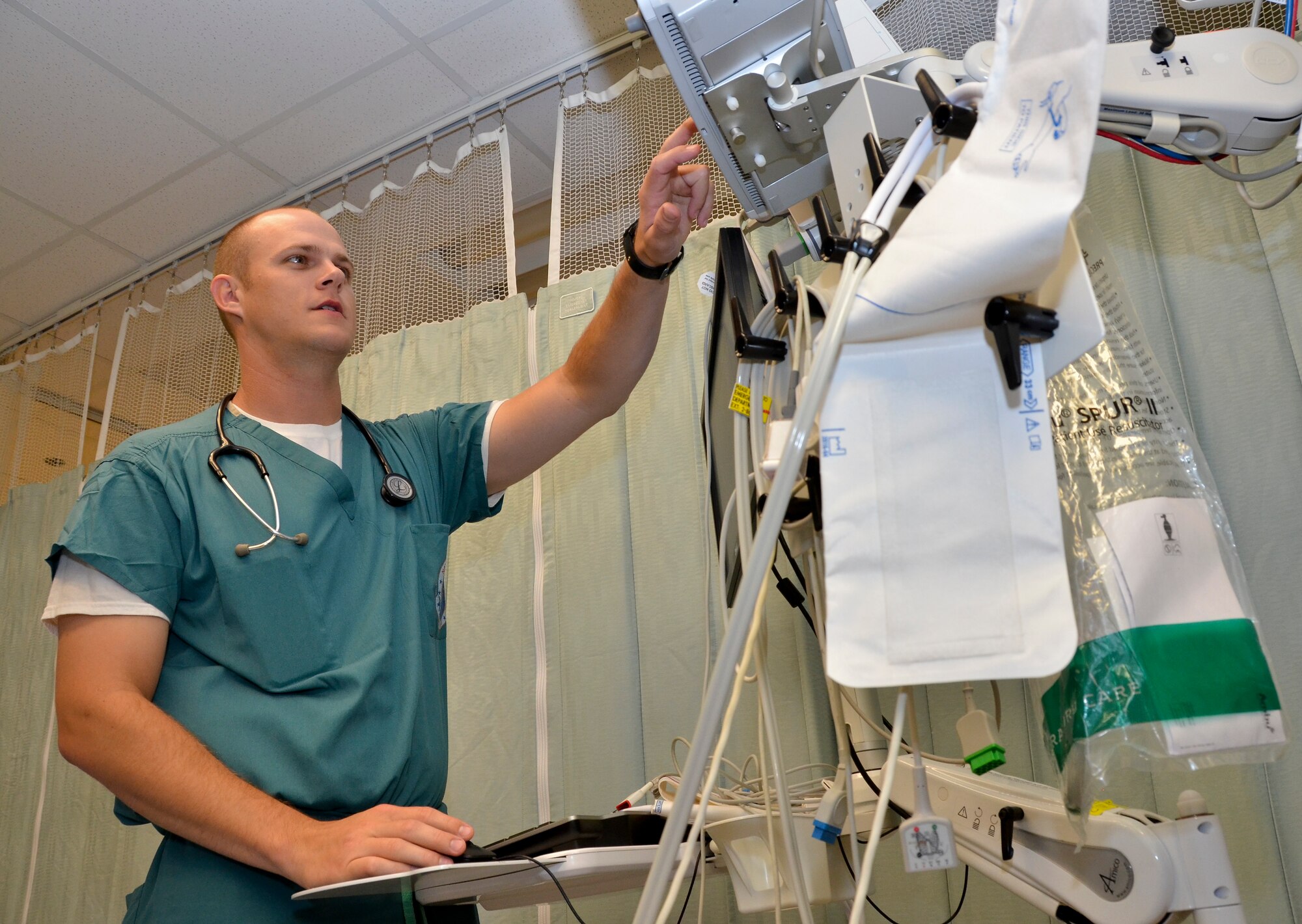 2nd Lt. Zachary Mabeus, nurse, 117th Medical Group, prepares a room for a patient at Naval Medical Center San Diego, in San Diego, Calif., June 29, 2016.  The 117 MDG trained with the U.S. Navy at Naval Medical Center San Diego.  The training included Airmen being implemented in real world U.S. Naval operations.  (U.S. Air National Guard photo by Staff Sgt. Jeremy Farson/Released)   