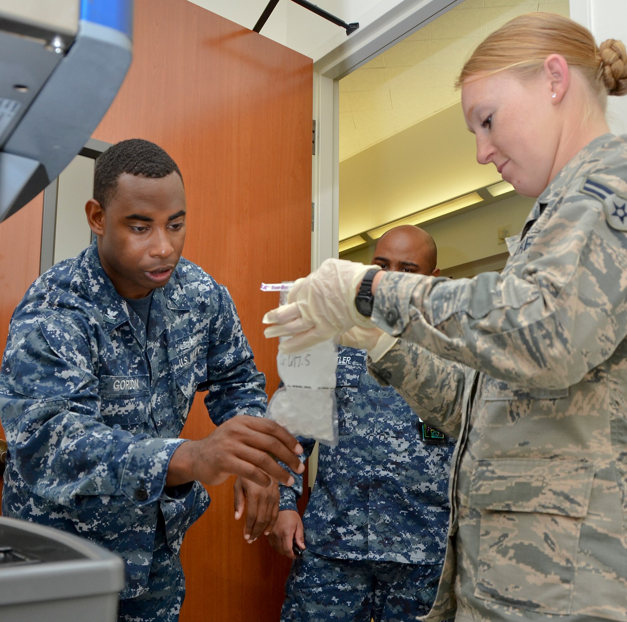 Airman 1st Class Tiffany Thornhill (right), preventative medicine, 117th Medical Group, and Petty Officer 3rd Class Julian Gordon, corpsman, preventative medicine, Naval Medical Center San Diego, collect ice to test for safe consumption, in San Diego, Calif., June 28, 2016.  The 117 MDG trained with the U.S. Navy at Naval Medical Center San Diego.  The training included Airmen being implemented in real world U.S. Naval operations.  (U.S. Air National Guard photo by Staff Sgt. Jeremy Farson/Released)   