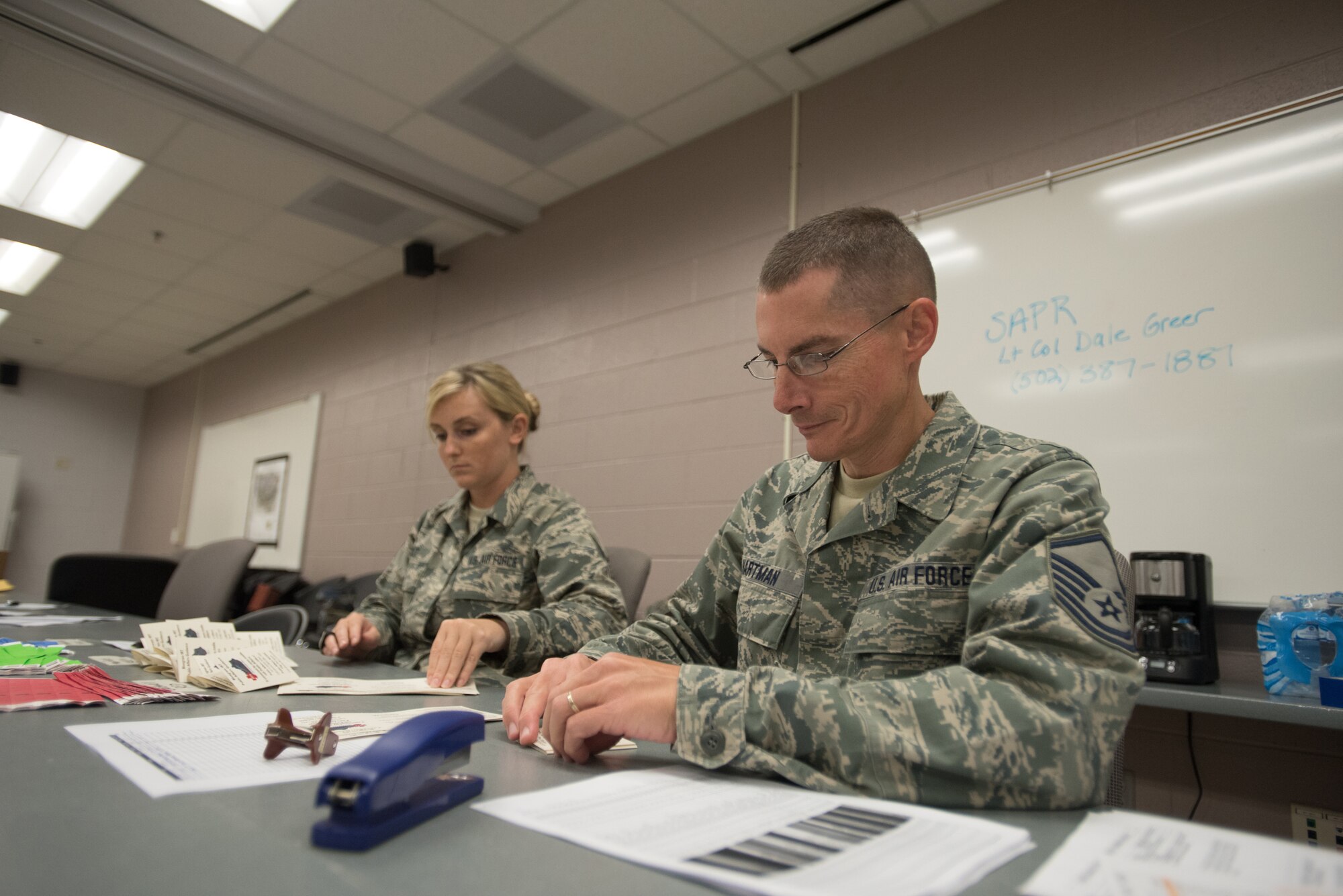 Master Sgt. Don Hartman (right) and Staff Sgt. Kayla Holt, personnel support specialists for the Kentucky Air National Guard’s 123rd Force Support Squadron, wait to in-process military members at Barkley Regional Airport in Paducah, Ky., July 16, 2016, in preparation for Bluegrass Medical Innovative Readiness Training. The program will offer medical and dental care at no cost to residents in three Western Kentucky locations from July 18 to 27. (U.S. Air National Guard photo by Master Sgt. Phil Speck)