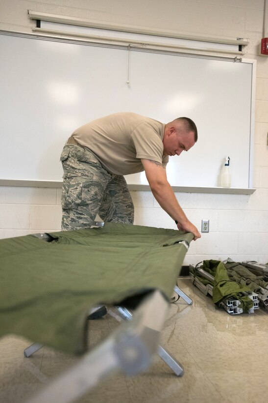 Tech. Sgt. Cody McNaughton, food services specialist for the New Jersey Air National Guard’s 108th Force Support Squadron, prepares cots for military members that will support Bluegrass Medical Innovative Readiness Training at Carlisle County High School in Bardwell, Ky., July 14, 2016. The program will offer medical and dental care at no cost to residents in three Western Kentucky locations from July 18 to 27. (U.S. Air National Guard photo by Master Sgt. Phil Speck)