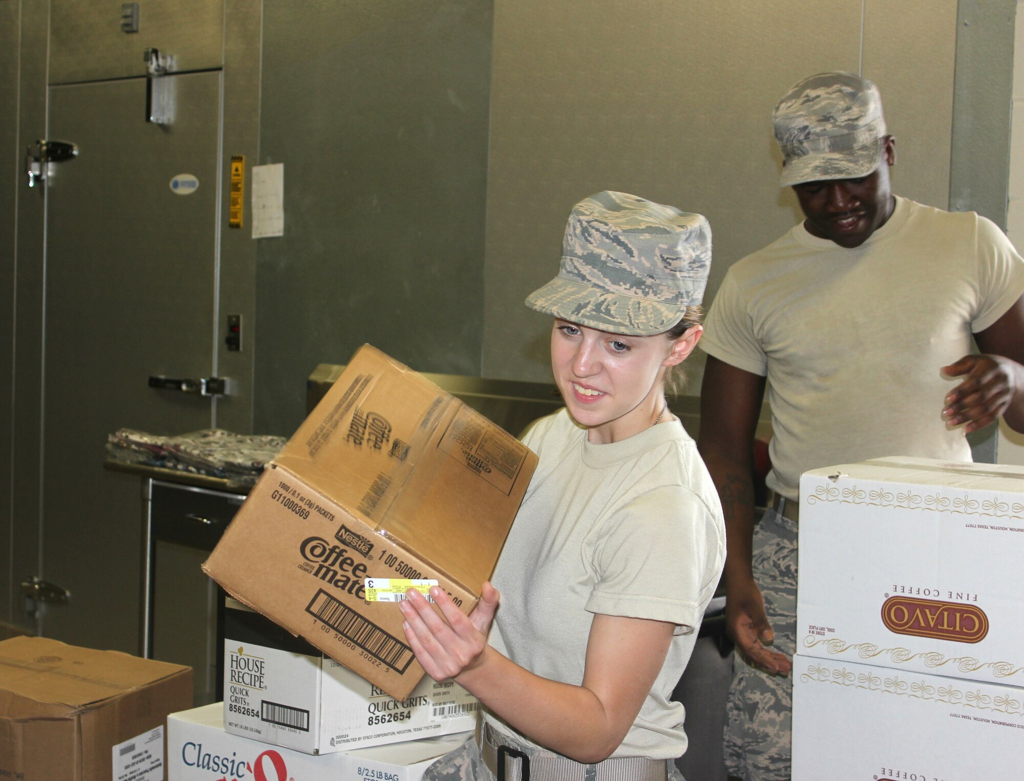 Airman First Class Katie Wainwright and Staff Sgt. Marcus Roberts, food services personnel in the New Jersey Air National Guard's 108th Force Support Squadron, organize food supplies at Carlisle County High School in Bardwell, Ky., July 14, 2016. The Kentucky Air National Guard and the U.S. Navy Reserve will provide medical and dental care at no cost to residents in three Western Kentucky locations from July 18 to 27 as part of Bluegrass Medical Innovative Readiness Training, a program co-sponsored by the U.S. Department of Defense and the Delta Regional Authority. (U.S. Navy Reserve photo by Petty Officer 2nd Class Cathan Bricker)