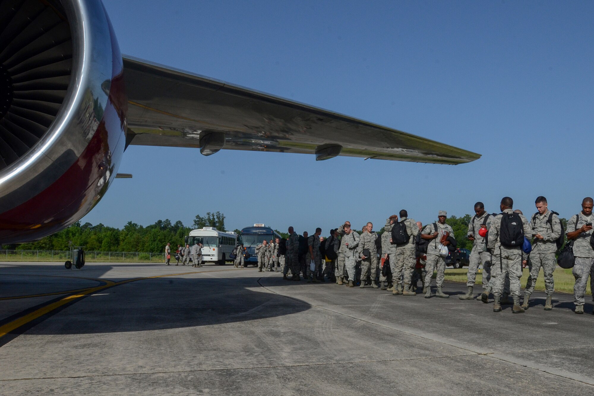 U.S. Air Force Airmen assigned to the South Carolina Air National Guard prepare to board a Boeing 767 transport aircraft at McEntire Joint National Guard Base, S.C., July 13, 2016. Approximately 300 U.S. Airmen and 12 F-16 Fighting Falcon fighter jets from the 169th Fighter Wing at McEntire JNGB, S.C., are deploying to Osan Air Base, Republic of Korea, as the 157th Expeditionary Fighter Squadron in support of the U.S. Pacific Command Theater Security Package. (U.S. Air National Guard photo by Airman 1st Class Megan Floyd)