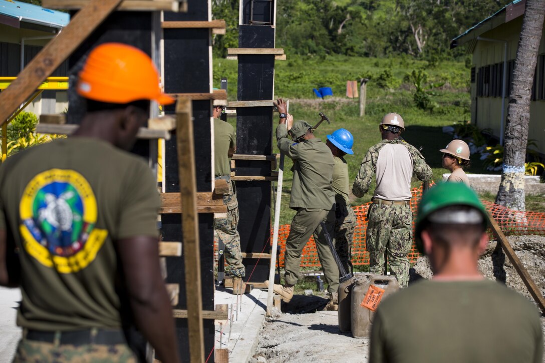 U.S. Marines, Sailors, and Soldiers from the Republic of Fiji Military Forces, conduct vertical construction training at Ovalau, Fiji, July 12, 2016. Fiji is part of Task Force Koa Moana’s deployment throughout the Asia-Pacific region where Marines and Sailors will share engineering and infantry skills with the Republic of Fiji Military Forces to strengthen mil-to-mil relationships and interoperability. (U.S. Marine Corps imagery by MCIPAC Combat Camera Lance Cpl. Jesus McCloud/ Released)