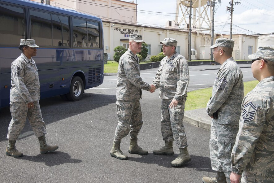 Gen. Carlton Everhart, Air Mobility Command commander, is greeted by Capt. Christopher Alfonso, 730th Air Mobility Squadron maintenance operations officer, before a tour at Yokota Air Base, Japan, July 10, 2016. Everhart toured 730 AMS facilities during a 515th Air Mobility Operations Wing Pacific visit. (U.S. Air Force photo by Senior Airman David C. Danford/Released)