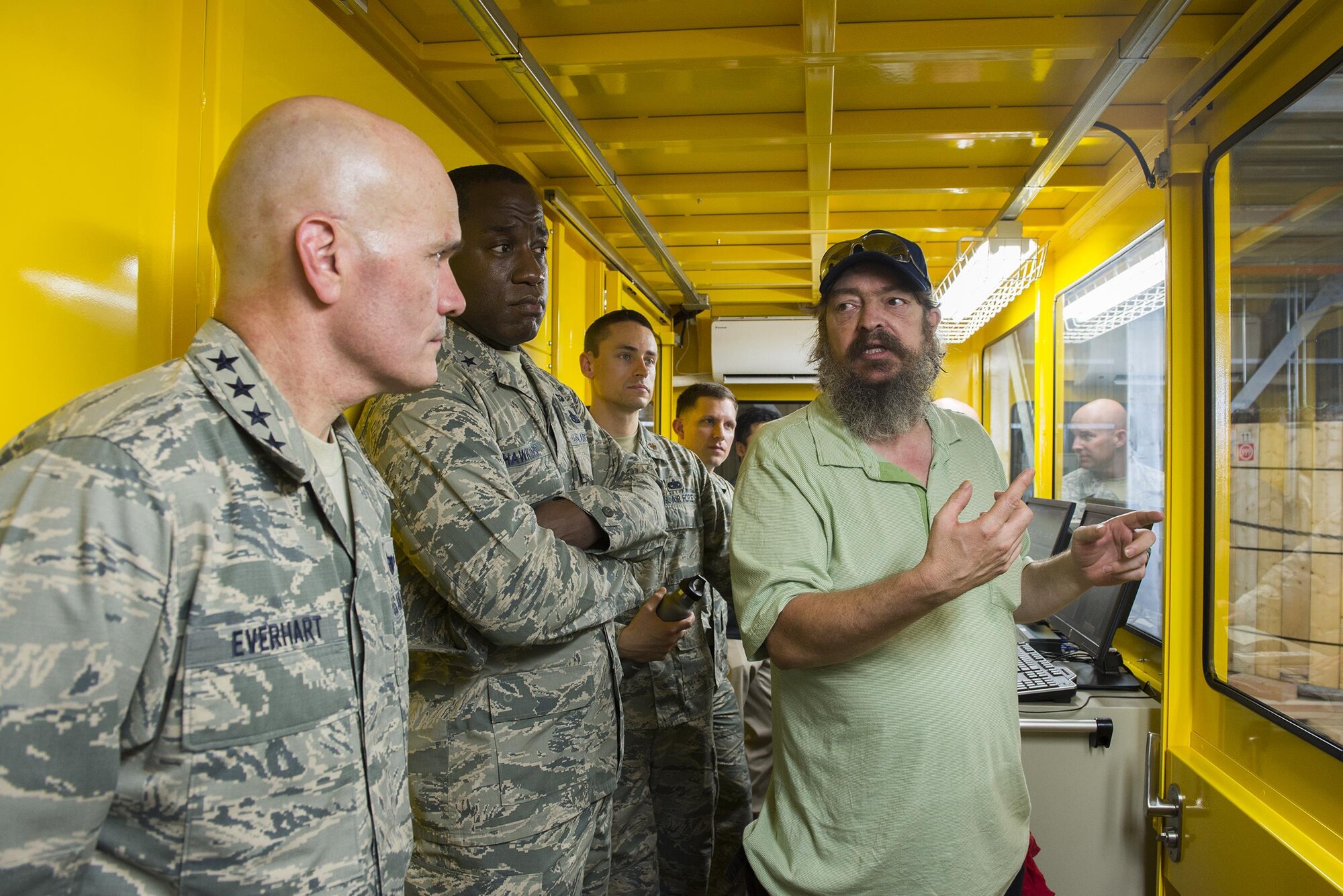 Gen. Carlton Everhart, Air Mobility Command commander, is briefed by Dean Labdon, 730th Air Mobility Squadron mechanized material handling system manager, on the MMHS capabilities at Yokota Air Base, Japan, July 10, 2016. The automated system sorts, records and stores pallets in the warehouse based on their destination. (U.S. Air Force photo by Senior Airman David C. Danford/Released)