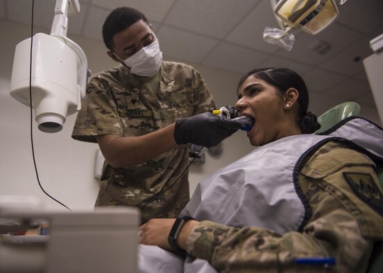 U.S. Army Specialist Anfernee Grant, 129th Area Support Medical Company dental technician, places a periapical X-ray device in a patient’s mouth, Bagram Airfield, Afghanistan, July 16, 2016. Grant assists U.S. Army Capt. John Mann, 129th Area Support Medical Company dentist, in an average of 100 emergency dental procedures per month. (U.S. Air Force photo by Senior Airman Justyn M. Freeman)