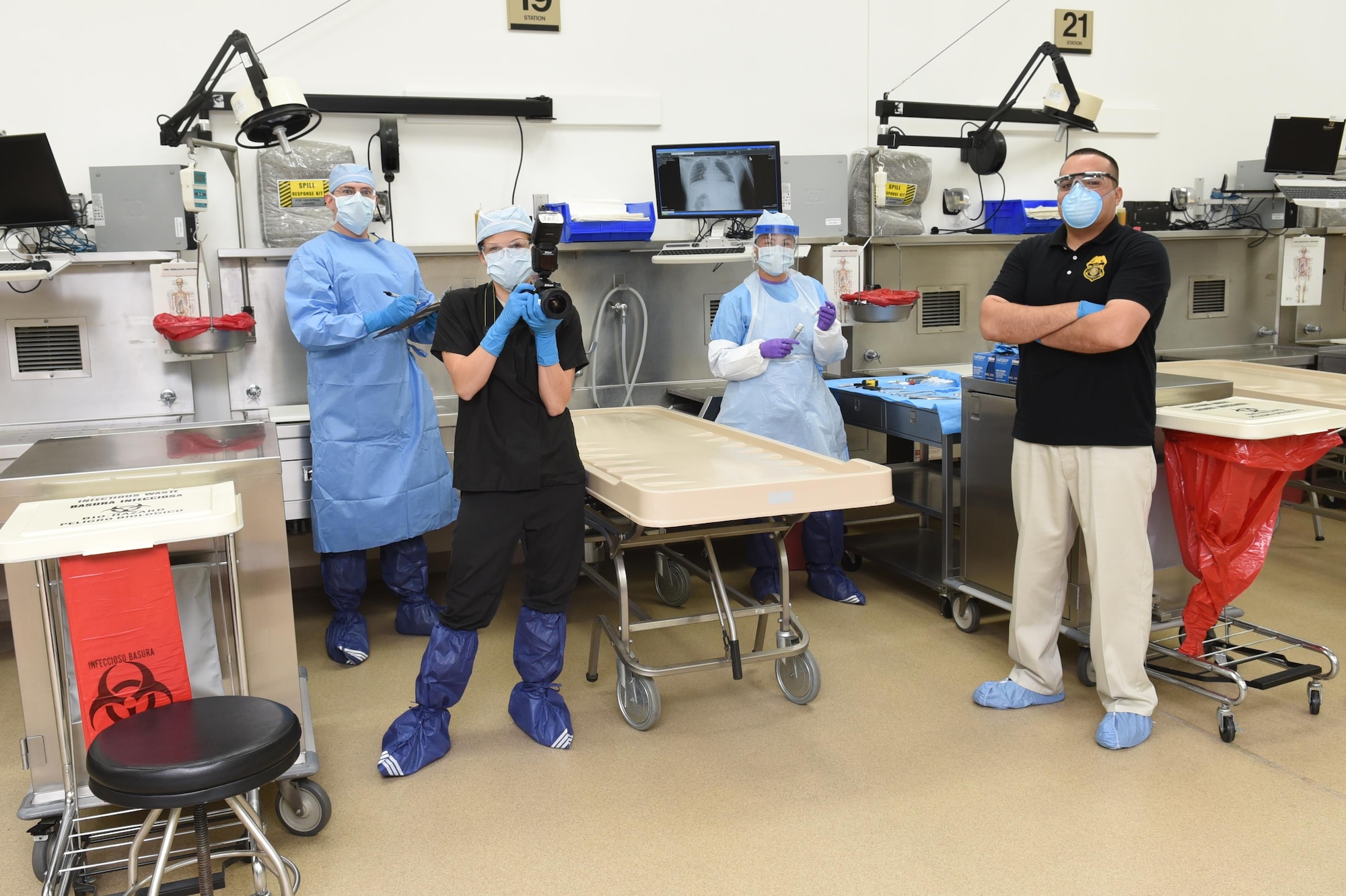 Office of the Armed Forces Medical Examiner personnel pose for a photo in the autopsy suite Sept. 10, 2015, at the Armed Forces Medical Examiner System on Dover Air Force Base, Del. OAFME personnel include board certified forensic pathologists, forensic anthropologists, medical-legal death investigators, photographers and mortuary affairs specialists. (U.S. Navy photo/Mass Communication Specialist 2nd Class Samantha Thorpe)