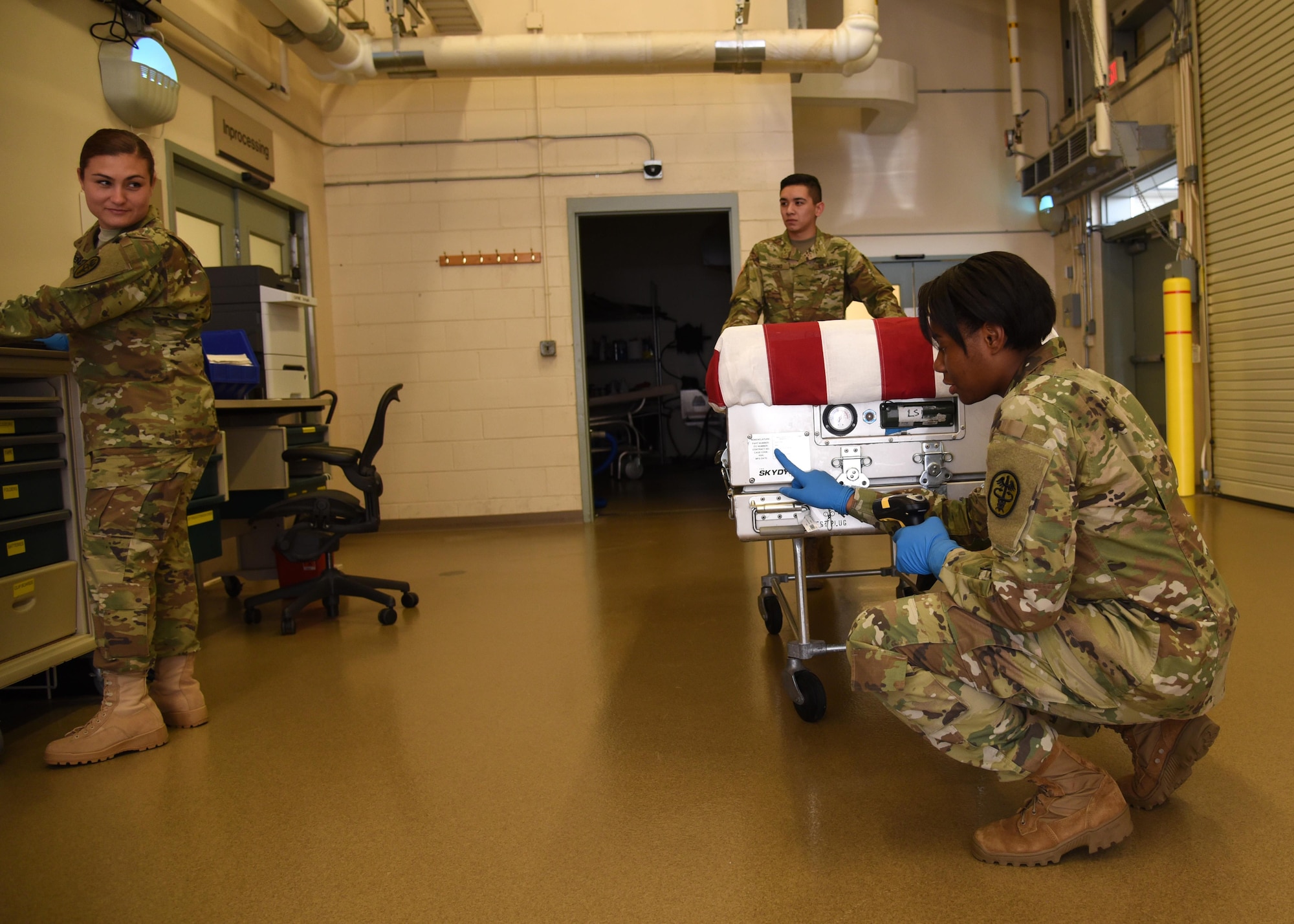 Office of the Armed Forces Medical Examiner mortuary affairs specialists demonstrate how to receive a decedent and intake them into the system July 11, 2016, at the Armed Forces Medical Examiner System on Dover Air Force Base, Del. Following a dignified transfer the decedent is brought to OAFME to undergo a medical-legal examination. (U.S. Air Force photo/Senior Airman Ashlin Federick) 