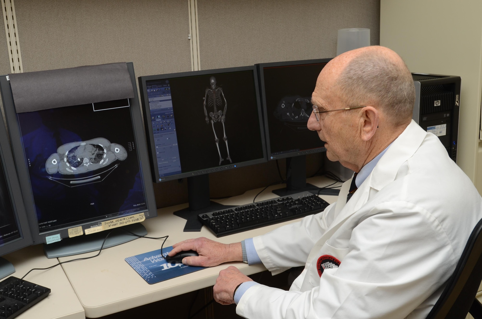 Dr. Howard Harcke, Office of the Armed Forces Medical Examiner forensic radiologist, looks at a CT scan for diagnostic clues Sept. 1, 2015, at the Armed Forces Medical Examiner System on Dover Air Force Base, Del. A full body scan is performed to help look for clues about how the decedent died or to look for internal bullet wounds (U.S. Navy photo/Mass Communications Specialist 2nd Class Samantha Thorpe)