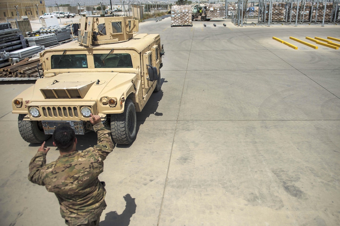 Senior Airman Brandon Misita guides a high-mobility multipurpose wheeled vehicle at Bagram Airfield, Afghanistan, July 14, 2016. Misita is a material recovery specialist assigned to the 455th Expeditionary Logistics Readiness Squadron Central Command. Air Force photo by Senior Airman Justyn M. Freeman