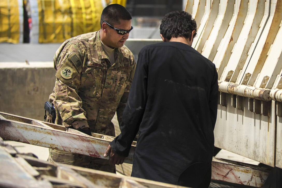 Air Force Staff Sgt. Jacob Chavez guides a vehicle ramp into place at Bagram Airfield, Afghanistan, July 14, 2016. Chavez is a material recovery specialist assigned to the 455th Expeditionary Logistics Readiness Squadron Central Command. Air Force photo by Senior Airman Justyn M. Freeman 