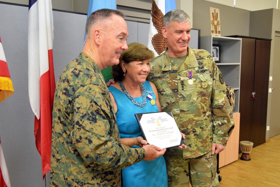Marine Corps Gen. Joe Dunford, left, chairman of the Joint Chiefs of Staff, poses for a photo with Army Gen. David M. Rodriguez, outgoing commander of U.S. Africa Command, and his wife, Ginny Rodriguez, who received the Distinguished Public Service Award for her support to families and the military community during a ceremony at Patch Barracks, U.S. Army Garrison Stuttgart, Germany, July 18, 2016. DoD photo by Adam Sanders