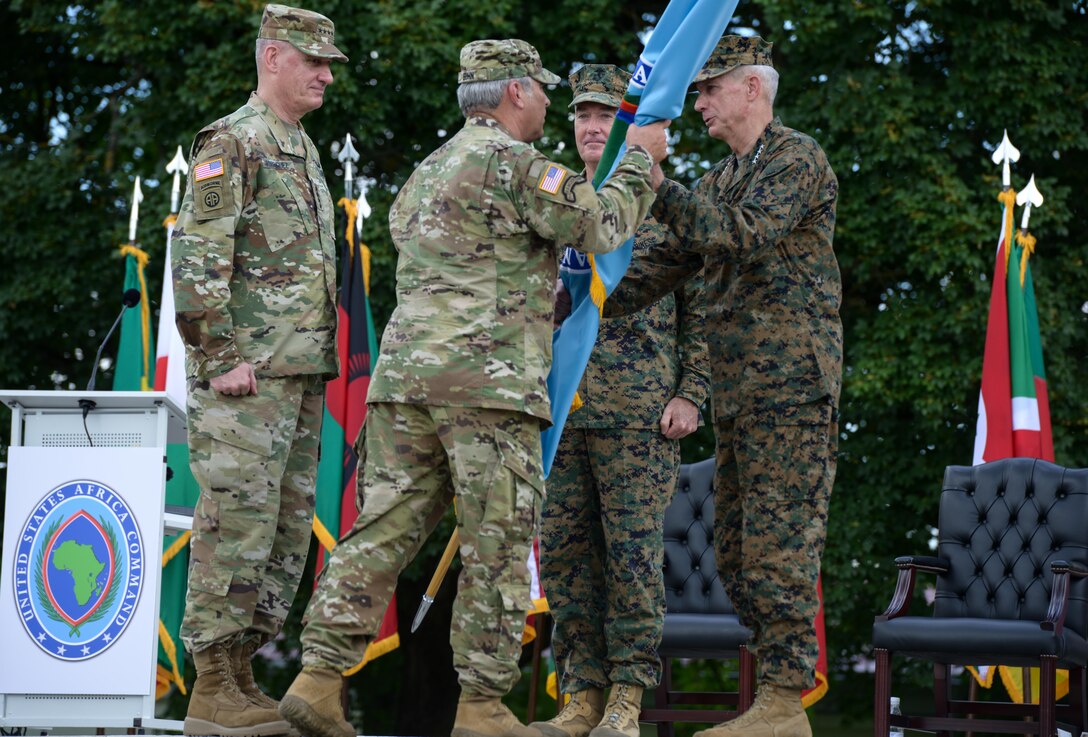Marine Corps Gen. Thomas D. Waldhauser passes the U.S. Africa Command flag to Command Sgt. Maj. Darrin J. Bohn, senior enlisted leader of U.S. Africa Command, signifying Waldhauser's assumption of command during a ceremony at U.S. Army Garrison Stuttgart, Germany, July 18, 2016. DoD photo by Jason Johnston