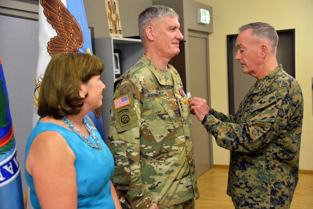 Marine Corps Gen. Joe Dunford, right, chairman of the Joint Chiefs of Staff, presents Army Gen. David M. Rodriguez, outgoing commander of U.S. Africa Command, with the Defense Distinguished Service Medal for his service as commander of U.S. Africa Command as his wife, Ginny, looks on during a ceremony at Patch Barracks at U.S. Army Garrison Stuttgart, Germany, July 18, 2016. DoD photo by Adam Sanders