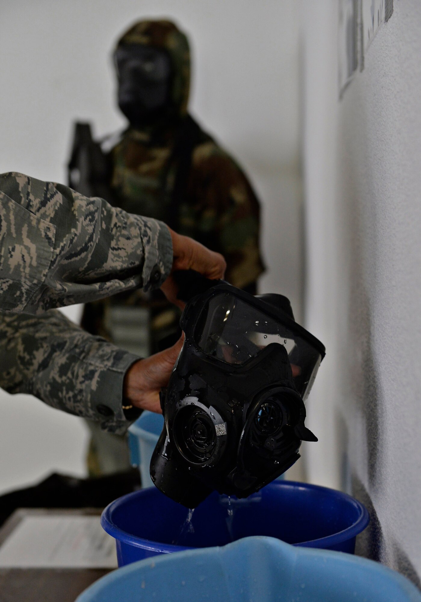 Senior Airman Andrea Vasquez, 86th Medical Support Squadron medical lab technician, cleans her gas mask at Ramstein Air Base, Germany, July 15, 2016. The 86th Logistics Readiness Squadron Individual Protective Equipment Element is currently working additional shifts to inspect all issued M-50 gas masks for leaks by July 30, 2016. (U.S. Air Force photo/ Senior Airman Nesha Humes)