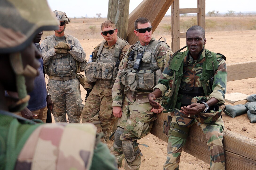 A Senegalese officer, right, assigned to the  1st Paratrooper Battalion, provides feedback to soldiers following a squad-level exercise during Africa Readiness Training 16 in Thies, Senegal, July 14, 2016. Army photo by Staff Sgt. Candace Mundt