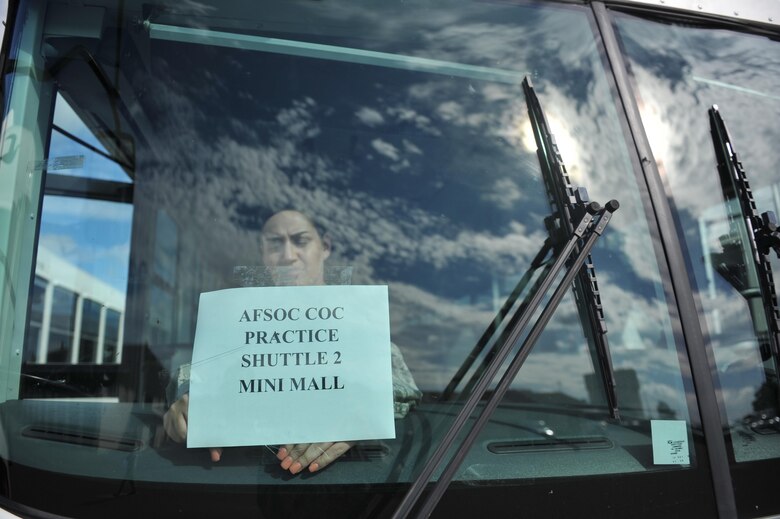 Senior Airman Lisa Exline, a vehicle operator with the 1st Special Operations Logistics Readiness Squadron, tapes a sign on the windshield of a bus at Hurlburt Field, Fla., July 15, 2016. The 1st SOLRS transports Air Commandos in support of base events and operations. (U.S. Air Force photo by Airman Dennis Spain)
