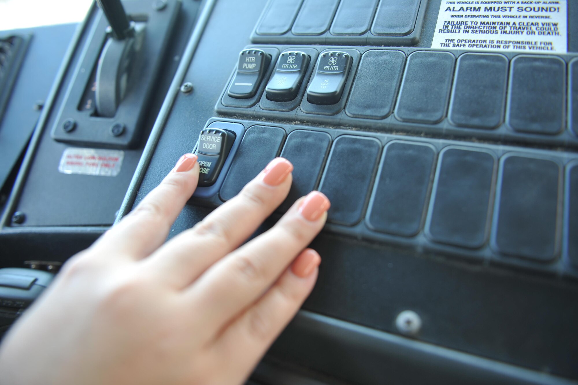 Senior Airman Lisa Exline, a vehicle operator with the 1st Special Operations Logistics Readiness Squadron, pressed a button to open the vehicle doors at Hurlburt Field, Fla., July 15, 2016. The 1st SOLRS will be supporting the Air Force Special Operations Command Change of Command July 19, 2016, by providing a shuttle service. Pickup locations include the Base Chapel, the Aderholt Gym, 4th Aircraft Maintenance Unit and the Base Exchange. (U.S. Air Force photo by Airman Dennis Spain)
