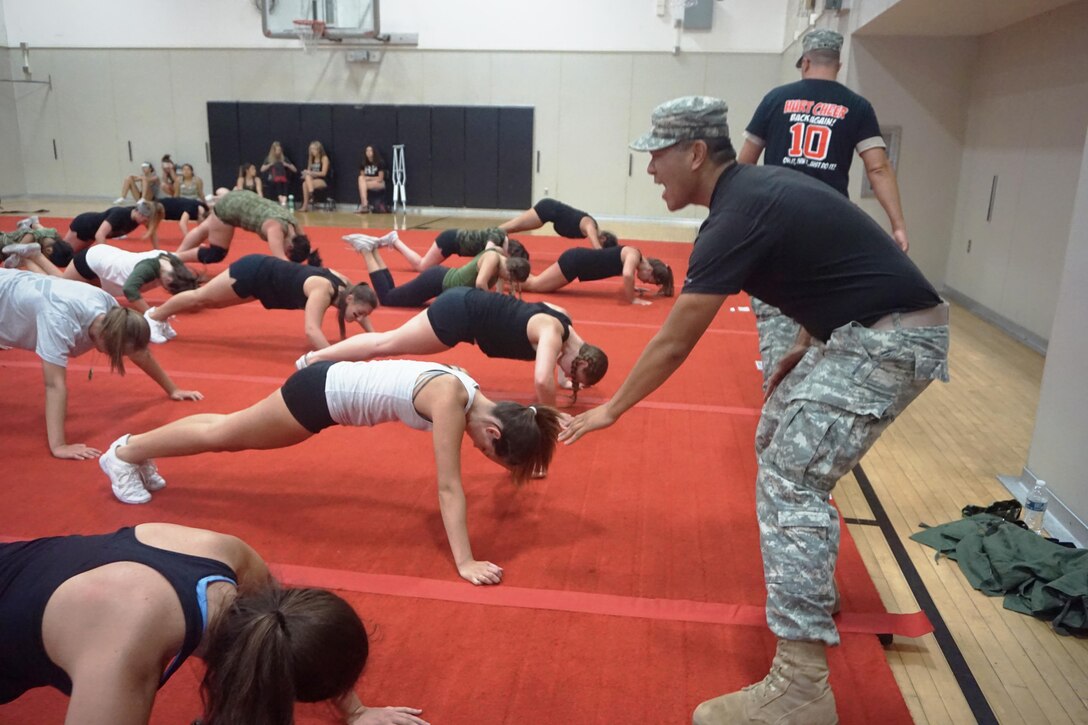 Msg. Brian McWilliams and Cpl. Timothy Yao, 311th Sustainment Command (Expeditionary), lead the William S. Hart High School cheerleaders in Army-style workouts to prepare the girls physically for their up-coming season. Instead of just dressing up for a spirit day, the coaches wanted to bring in Soldiers to help motivate the team. Santa Clarita, Calif. June 13, 2016.
(U.S. Army photo courtesy of Spc. Aracely Jimenez, 311th ESC)