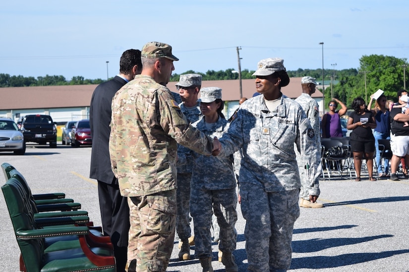 Lt. Col. Christopher J. Buzard, commander of the 313th Movement Control Battalion, prepares to case the unit colors during a deployment ceremony on July 10, 2016, in Baltimore, Md., at the 1SG Adam S. Brandt United States Army Reserve Center. The 313th MCB is scheduled to deploy to the Middle East in support of Operation Enduring Freedom.