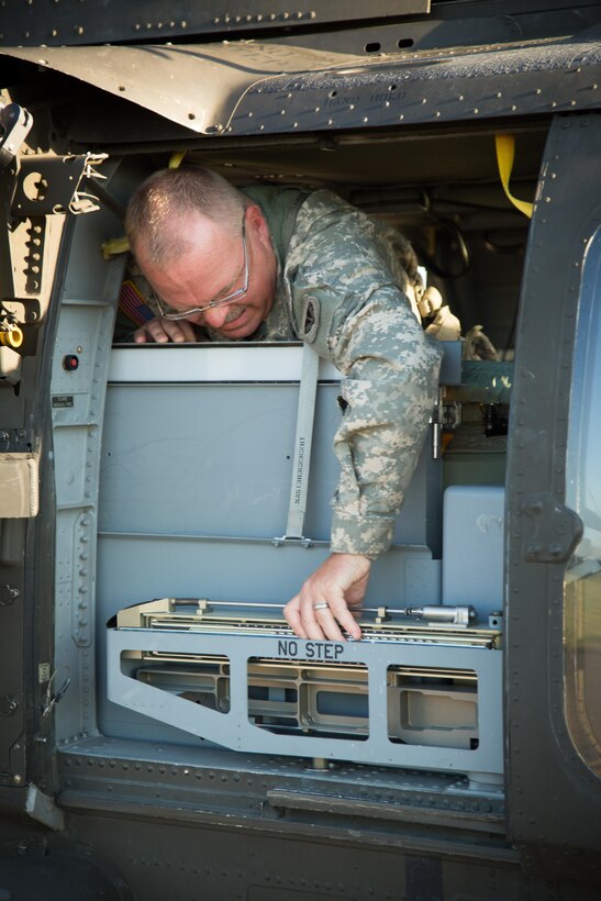 U.S. Army National Guard 1st Sgt. Patrick Deuberry, F Company, 2-238th General Support Aviation Battalion, West Bend, Wis., conducts preflight checks on a UH-60 Blackhawk helicopter prior to a flight mission during Warrior Exercise (WAREX) 86-16-03 at Fort McCoy, Wis., July 14, 2016. WAREX is designed to keep soldiers all across the United States ready to deploy. (U.S. Army photo by Sgt. Robert Farrell/Released)