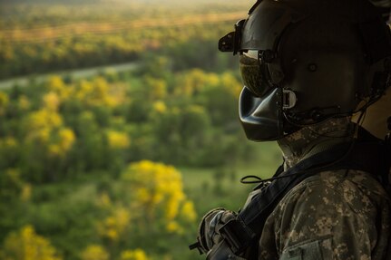 U.S. Army National Guard Spc. Caleb Estenson, F Company, 2-238th General Support Aviation Battalion, West Bend, Wis., monitors flight conditions in a UH-60 Blackhawk helicopter during Warrior Exercise (WAREX) 86-16-03 at Fort McCoy, Wis., July 14, 2016. WAREX is designed to keep soldiers all across the United States ready to deploy. (U.S. Army photo by Sgt. Robert Farrell/Released)