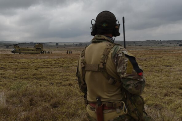 A combat controller with the 320th Special Tactics Squadron watches as Army Special Forces and Marine Raiders board a CH-47 Chinook after a multi-aircraft, joint airborne operation with special operations assets and conventional forces from all four branches of the U.S. Armed Forces as part of Rim of the Pacific (RIMPAC) 2016 to strengthen their relationships and interoperability with their partners, Pohakuloa Training Area, Hawaii, July 14, 2016. RIMPAC 2016 is the 25th exercise in the series that began in 1971.(U.S. Air Force photo by 2nd Lt. Jaclyn Pienkowski/Released)
