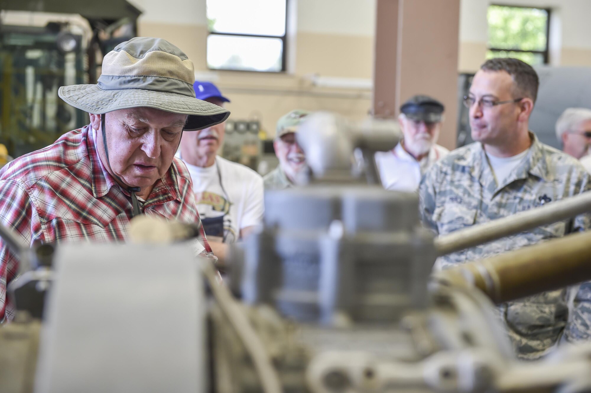 A member of the Veteran Motor Car Club of America (VMCCA) views a cutaway C-130 Engine as Senior Master Sgt. Bob Pierce, superintendent of the propulsion shop here, explains how it works July 15, 2016. VMCCA members brought approximately 15 vehicles and 35 guests to tour the installation and stayed afterward to provide 910th members a viewing of their vehicles. Their cars are all restored one and two cylinder functioning historic vehicles from the early 1900s. (U.S. Air Force photo/Eric White)